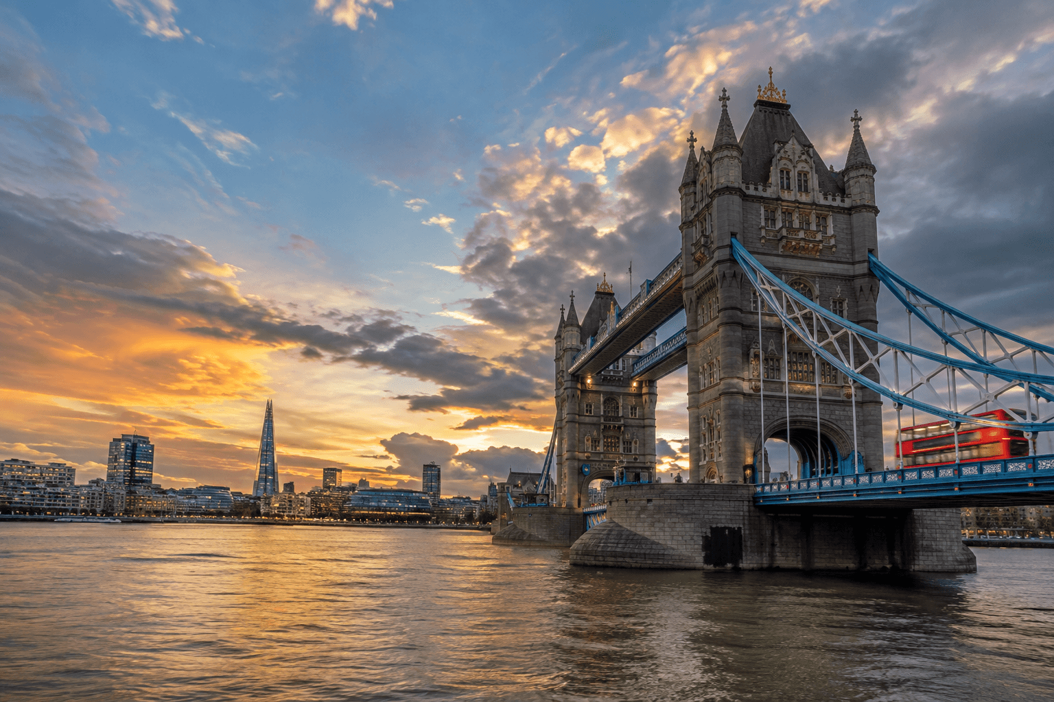 Tower Bridge and the London skyline at sunset, seen from the Thames